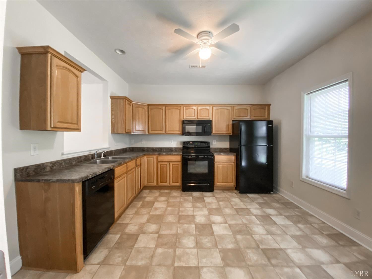 1600 Wards Ferry Road, Unit 103 Lynchburg, VA 24502 - Photo 2 of 23 a kitchen with stainless steel appliances granite countertop a refrigerator a sink a stove with wooden cabinets
