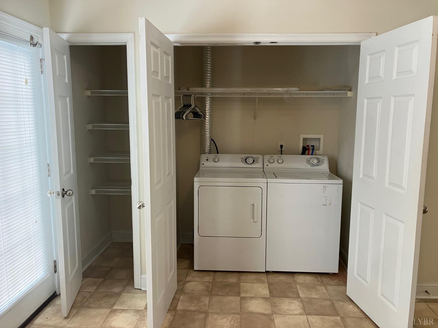 1600 Wards Ferry Road, Unit 103 Lynchburg, VA 24502 - Photo 22 of 23 a utility room with cabinets washer and dryer