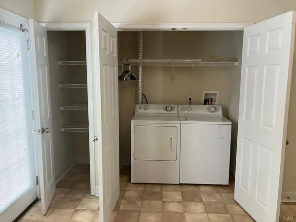 a utility room with cabinets washer and dryer