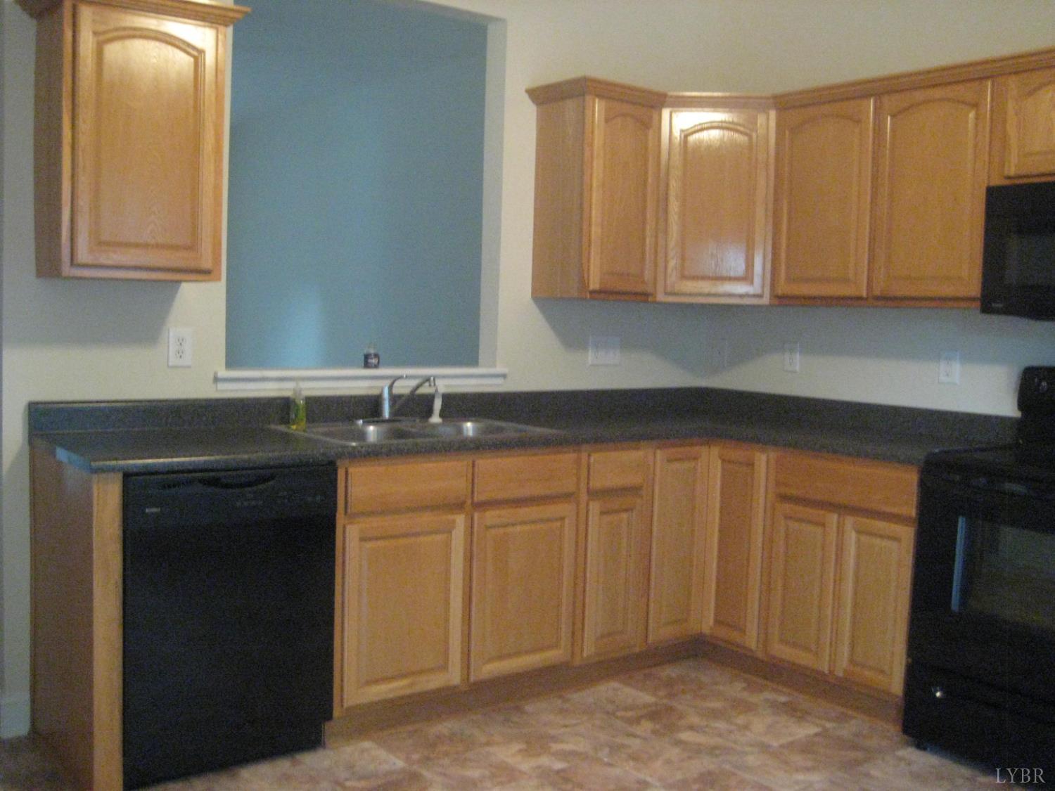 1600 Wards Ferry Road, Unit 103 Lynchburg, VA 24502 - Photo 3 of 23 a kitchen with granite countertop white cabinets and stainless steel appliances