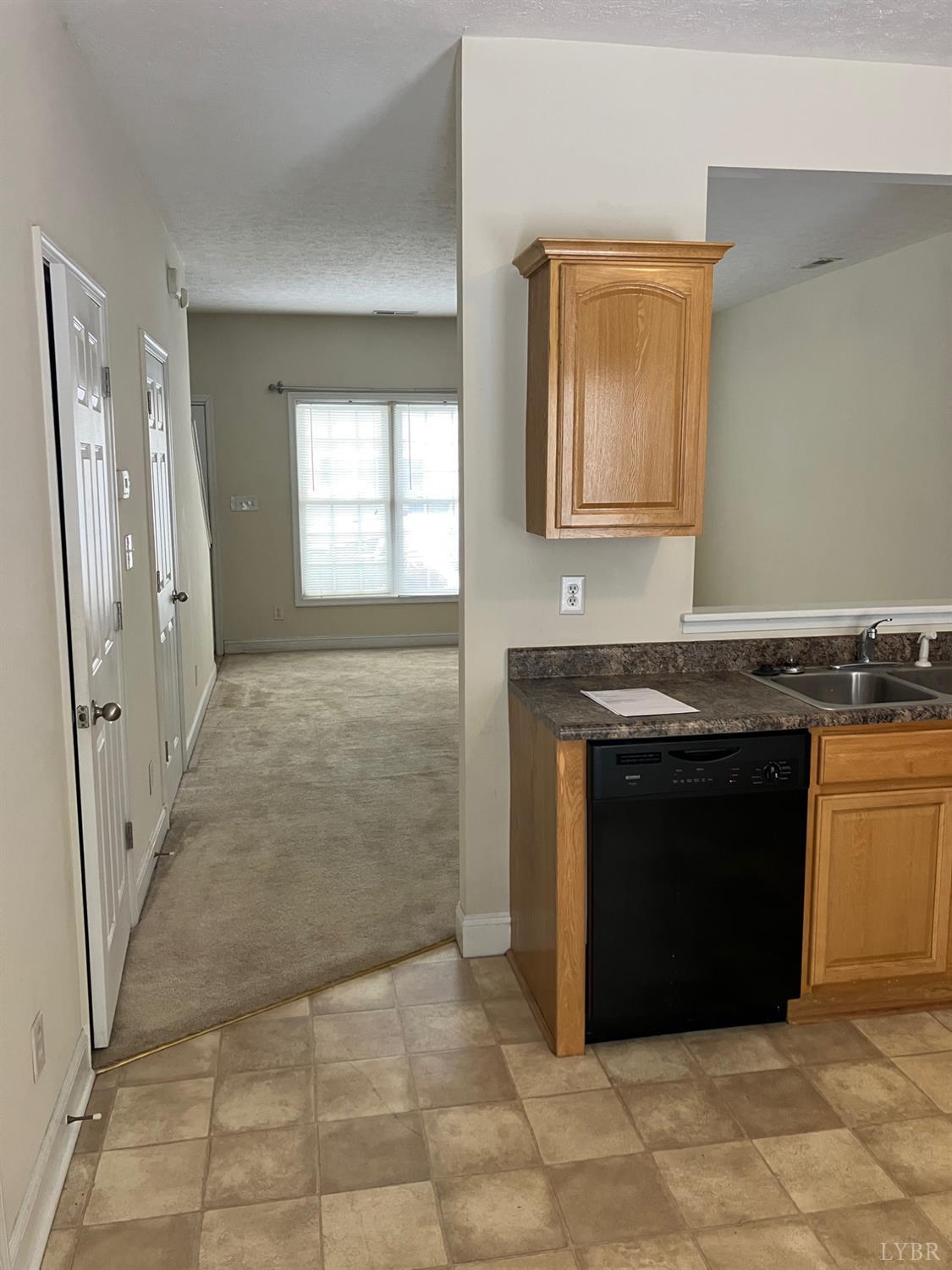 1600 Wards Ferry Road, Unit 103 Lynchburg, VA 24502 - Photo 7 of 23 a view of a kitchen with granite countertop cabinets and a stove top oven