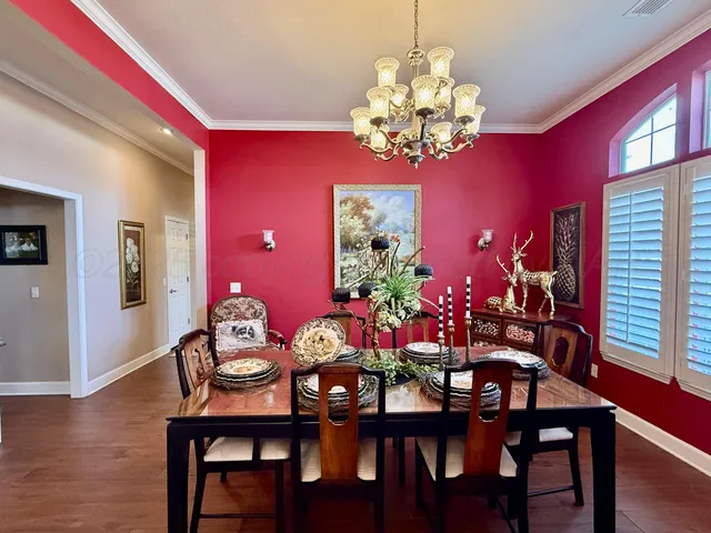 a view of a dining room with furniture and chandelier