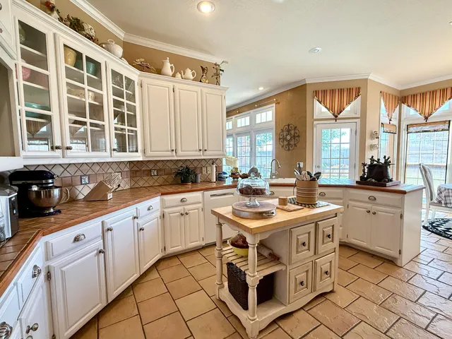 a kitchen with stainless steel appliances a stove a sink and a refrigerator
