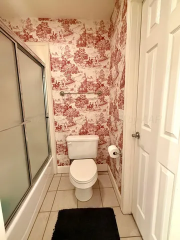 a bathroom with a toilet and a shower