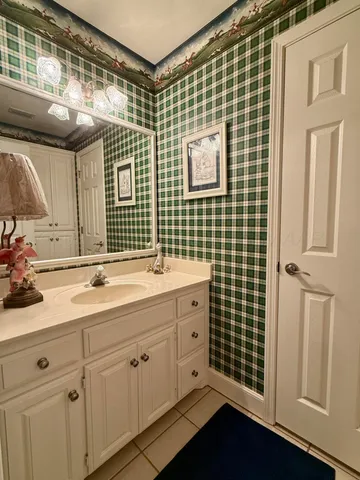 a bathroom with a sink a mirror and shower