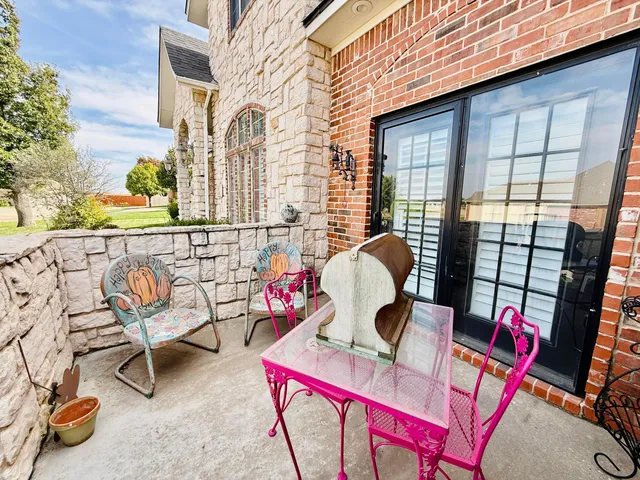 a backyard of a house with outdoor seating