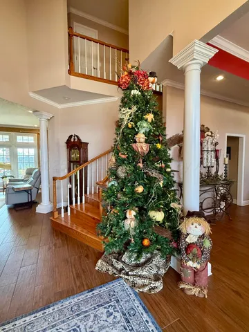 a view of a porch with furniture and hardwood floor