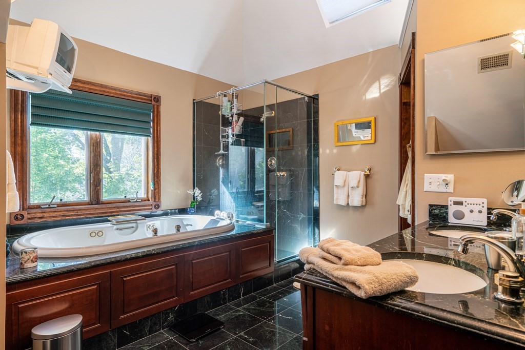 55 Waldeck Road Milton, MA 02186 - Photo 11 of 28 a bathroom with a granite countertop sink and a large mirror