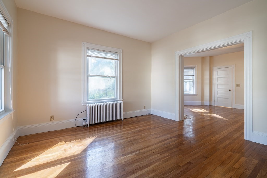 55 Waldeck Road Milton, MA 02186 - Photo 14 of 28 a view of an empty room with wooden floor and a window