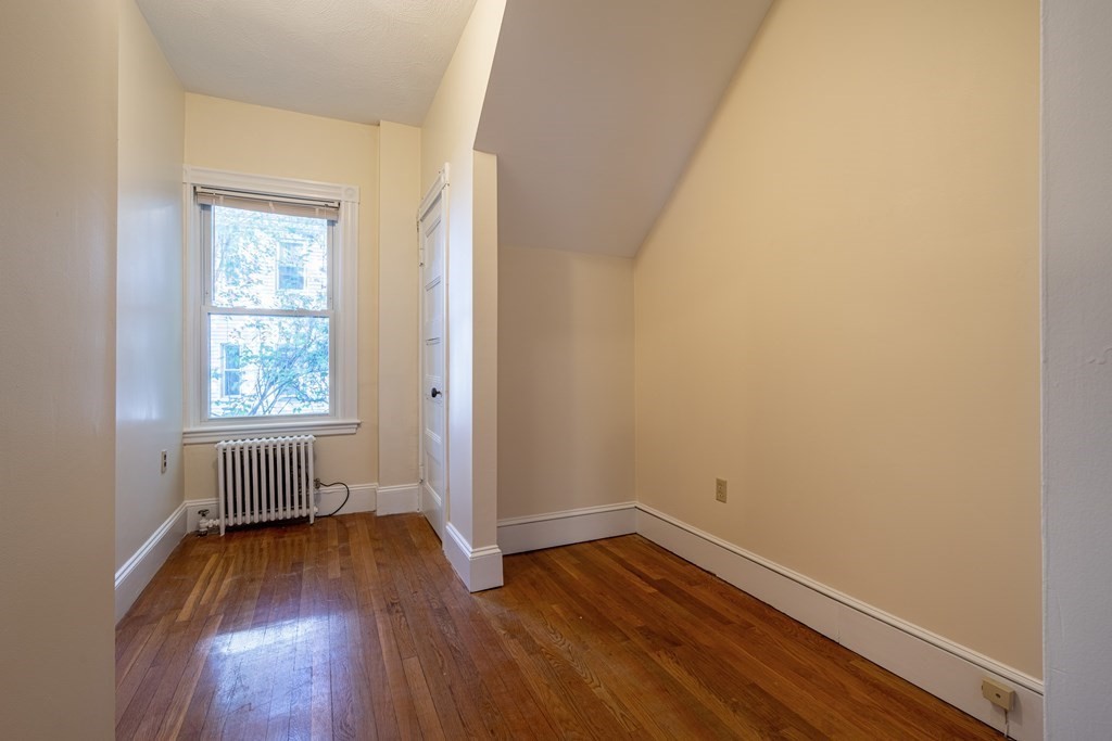 55 Waldeck Road Milton, MA 02186 - Photo 15 of 28 an empty room with wooden floor and windows