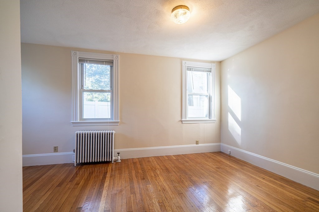 55 Waldeck Road Milton, MA 02186 - Photo 18 of 28 an empty room with wooden floor and windows