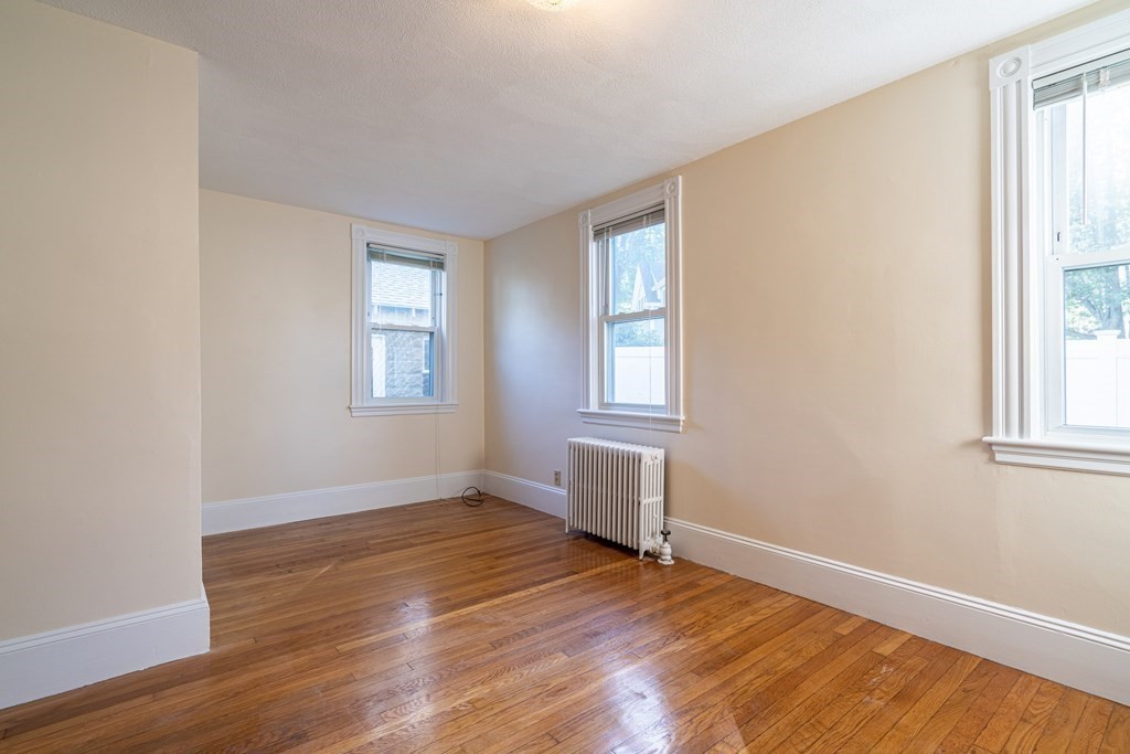 55 Waldeck Road Milton, MA 02186 - Photo 19 of 28 an empty room with wooden floor and windows