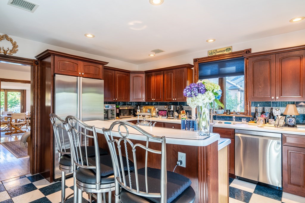 55 Waldeck Road Milton, MA 02186 - Photo 7 of 28 a kitchen with sink a stove and chairs
