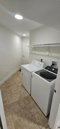 a bedroom with a bed and a flat tv screen on the dresser