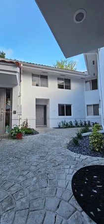 a view of a house with backyard and a garden