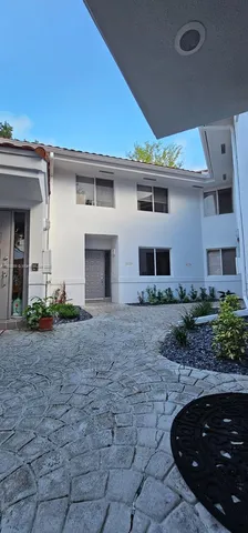 a view of a house with backyard and a garden