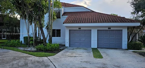a view of a house with a backyard