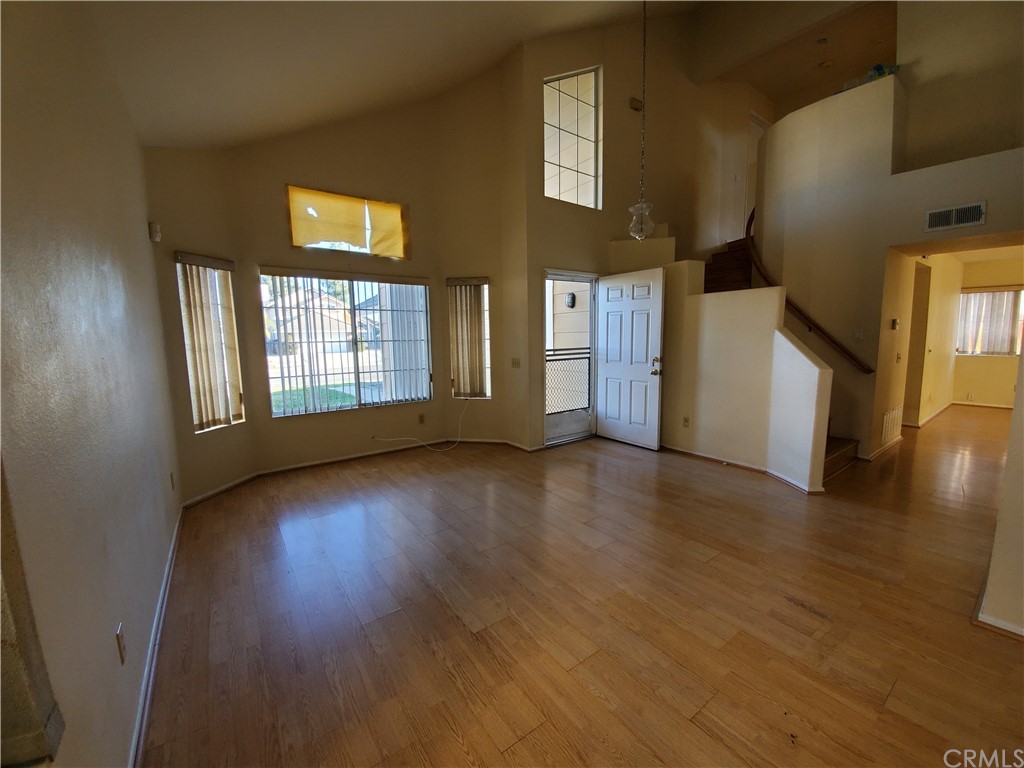 39837 Falcon Way Murrieta, CA 92562 - Photo 2 of 12 a view of an empty room with window and wooden floor