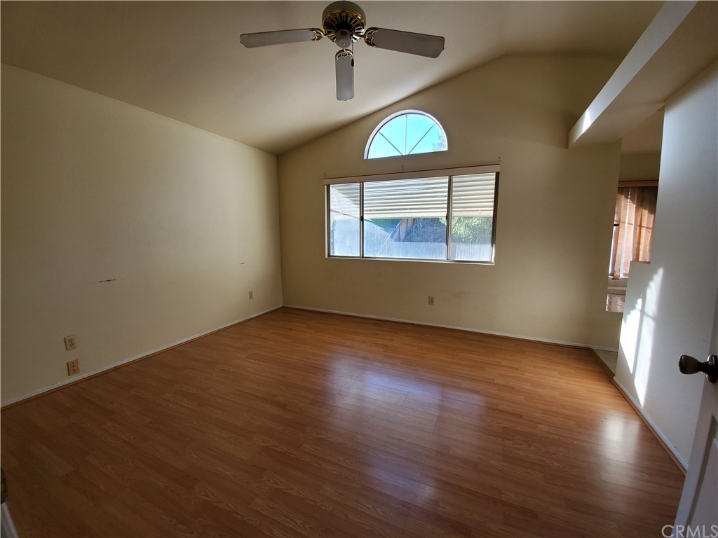 39837 Falcon Way Murrieta, CA 92562 - Photo 9 of 12 an empty room with wooden floor and windows