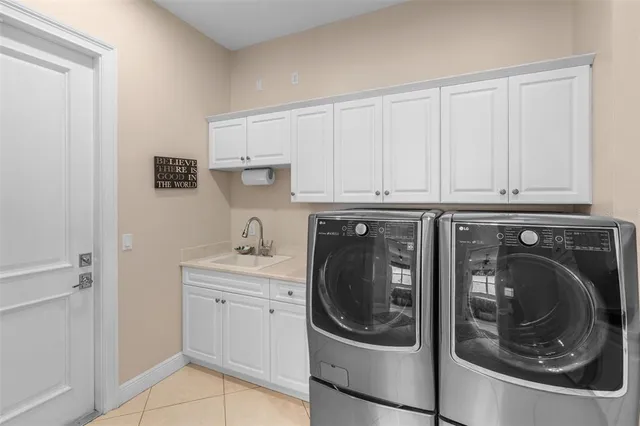 a utility room with sink dryer and washer