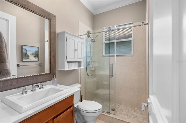 a bathroom with a sink vanity granite toilet and shower