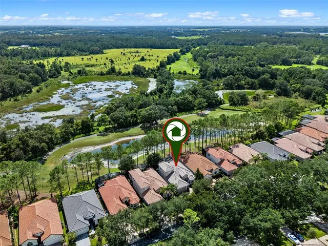 an aerial view of a house with garden space and street view
