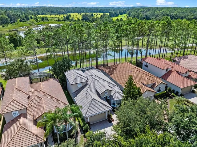 an aerial view of a houses with a yard