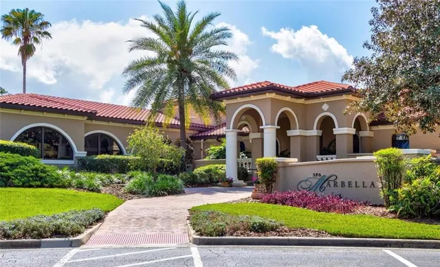 a view of a golf ground with huge green field and covered with trees