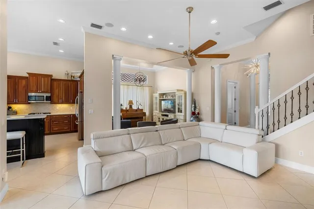 a living room with furniture and kitchen view