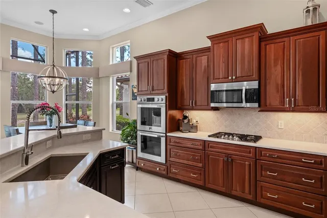 a kitchen with stainless steel appliances granite countertop a stove and a sink