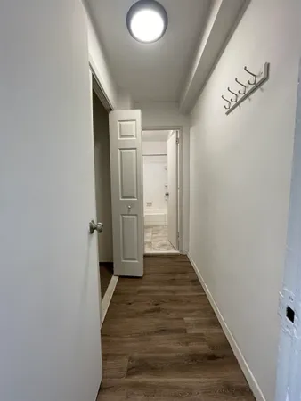 a view of a hallway with wooden floor and a hallway
