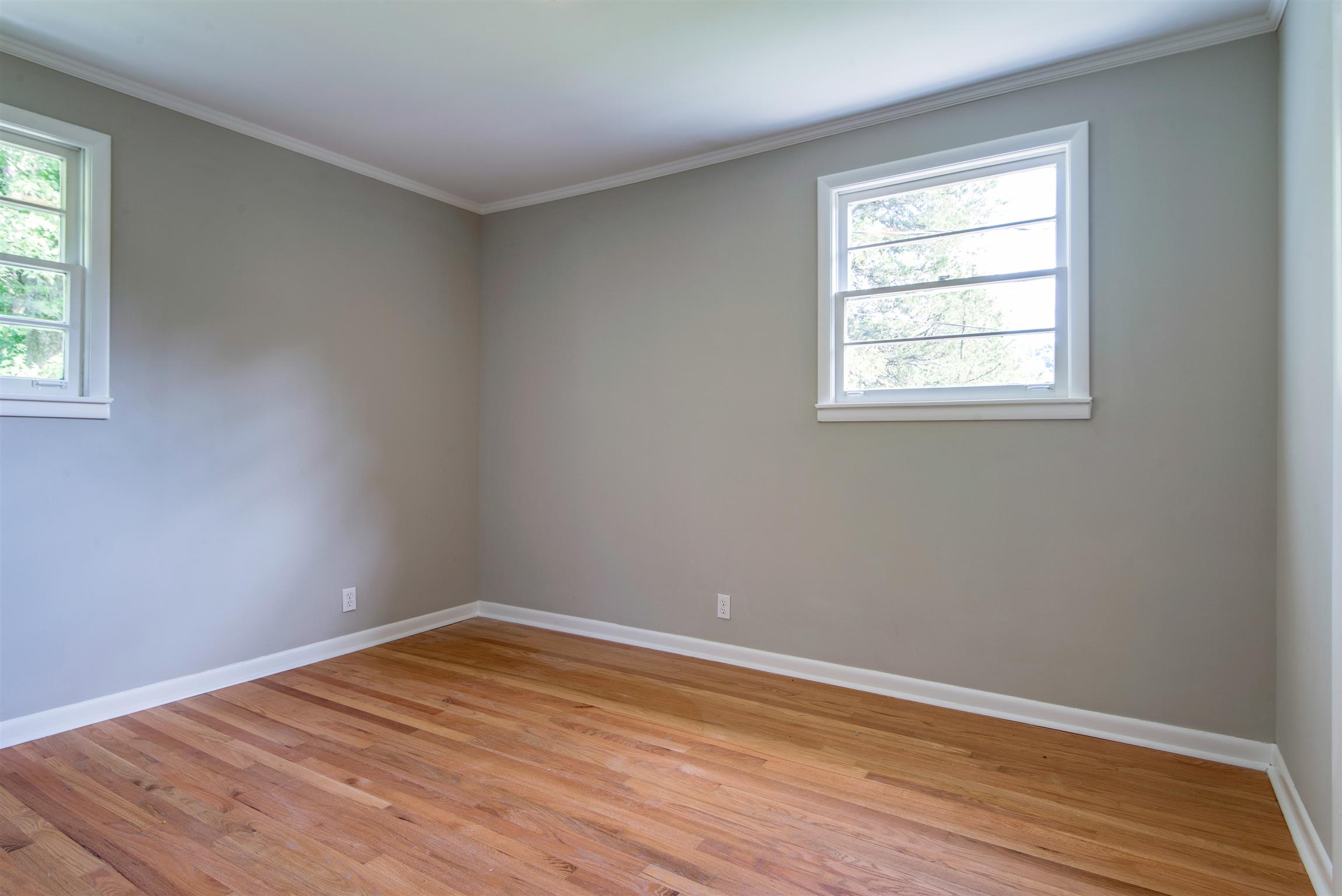 110 Dabney Drive Franklin, TN 37064 - Photo 12 of 25 an empty room with wooden floor and windows