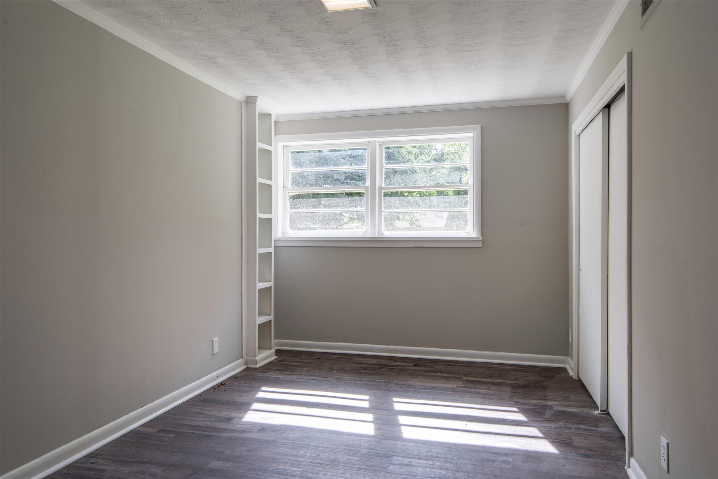 110 Dabney Drive Franklin, TN 37064 - Photo 13 of 25 an empty room with wooden floor and windows
