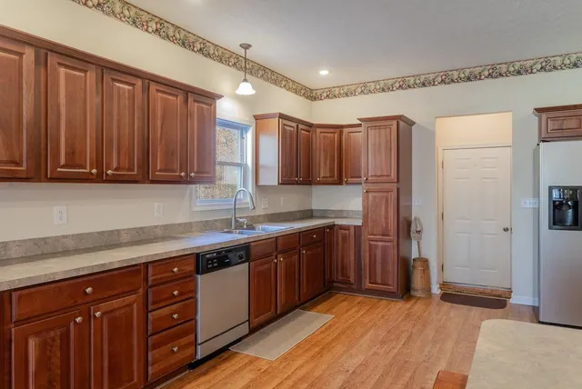 a kitchen with granite countertop a refrigerator stove and microwave