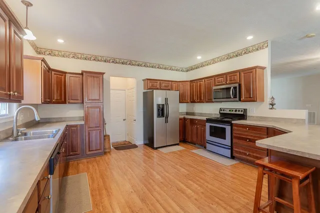 a kitchen with granite countertop cabinets sink and window