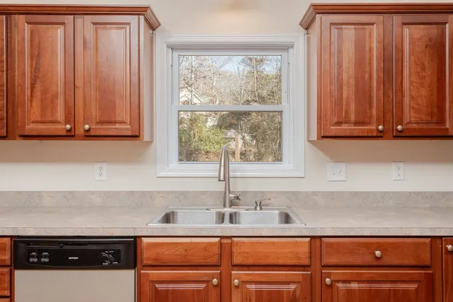a large kitchen with wooden floors and stainless steel appliances