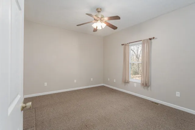 a bathroom with a granite countertop sink a toilet and a mirror