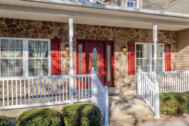 a view of a hallway with wooden floor and cabinet