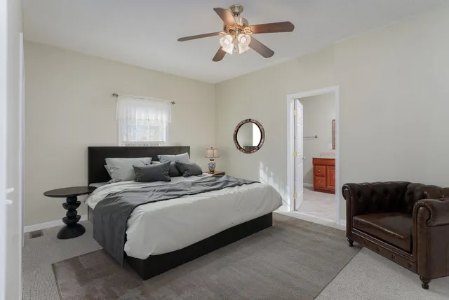 a living room with furniture a air conditioner and a window