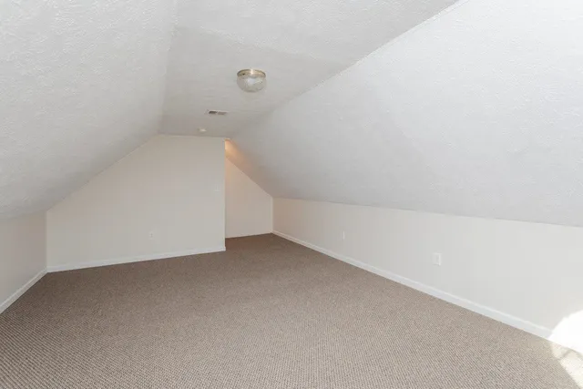 a view of a yard with wooden fence