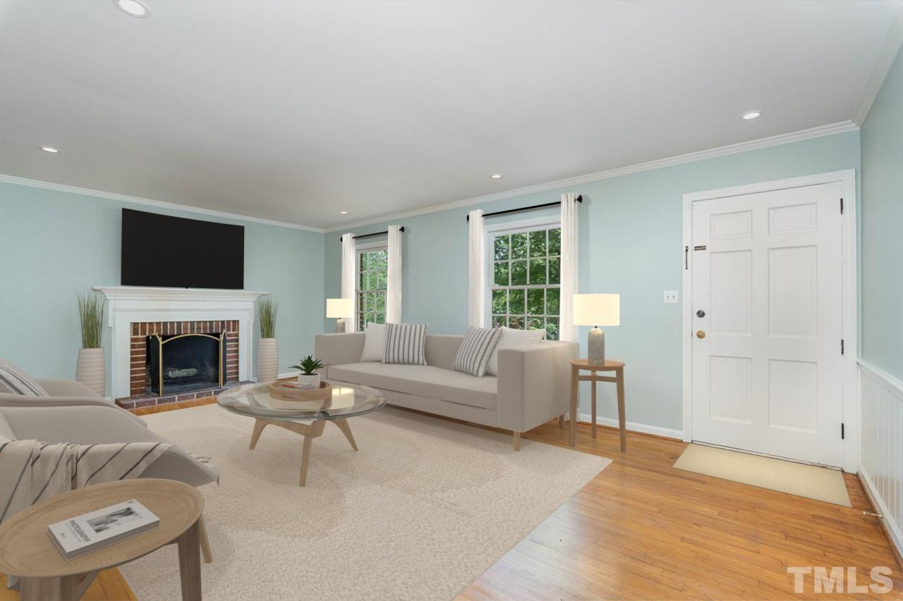 3406 Forest Road Raleigh, NC 27604 - Photo 14 of 31 a living room with furniture a fireplace and a flat screen tv