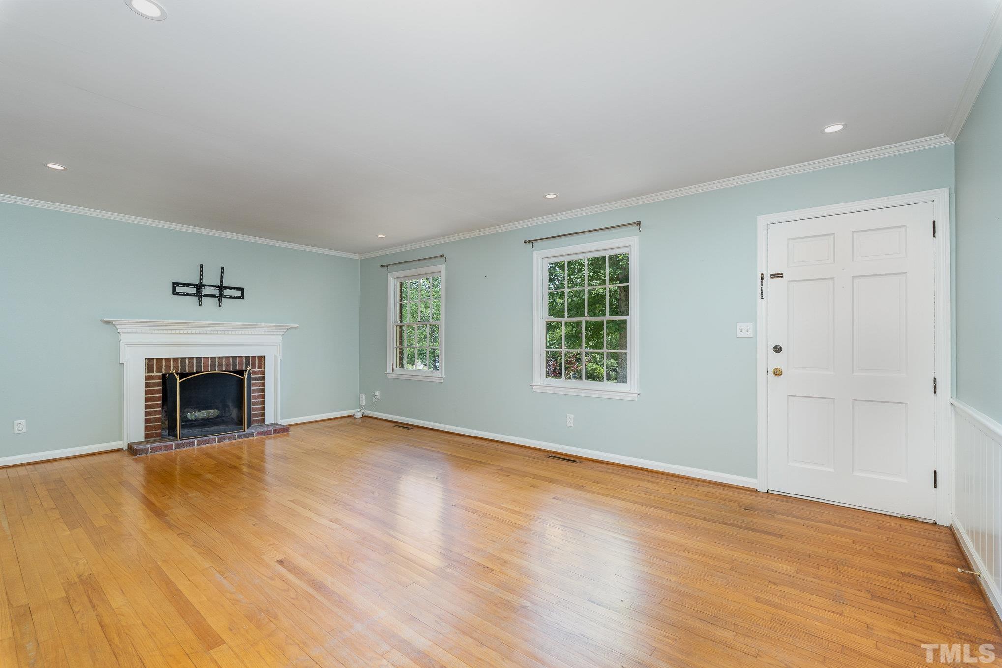 3406 Forest Road Raleigh, NC 27604 - Photo 15 of 31 a view of empty room with wooden floor and fireplace