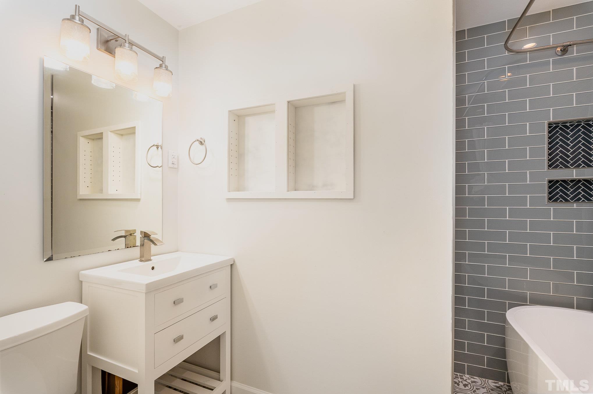 3406 Forest Road Raleigh, NC 27604 - Photo 18 of 31 a bathroom with a sink a toilet and mirror