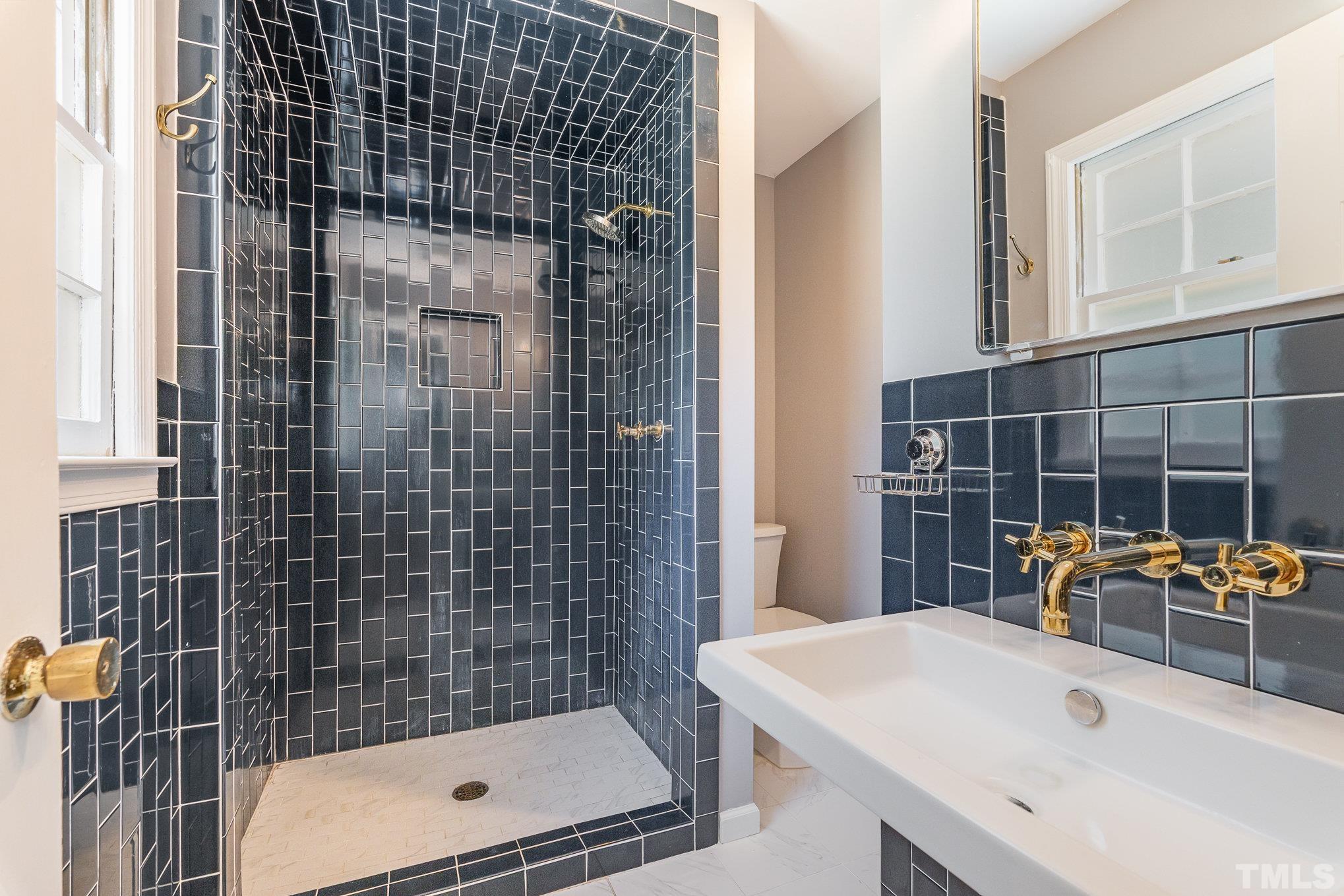 3406 Forest Road Raleigh, NC 27604 - Photo 21 of 31 a bathroom with a sink toilet and shower