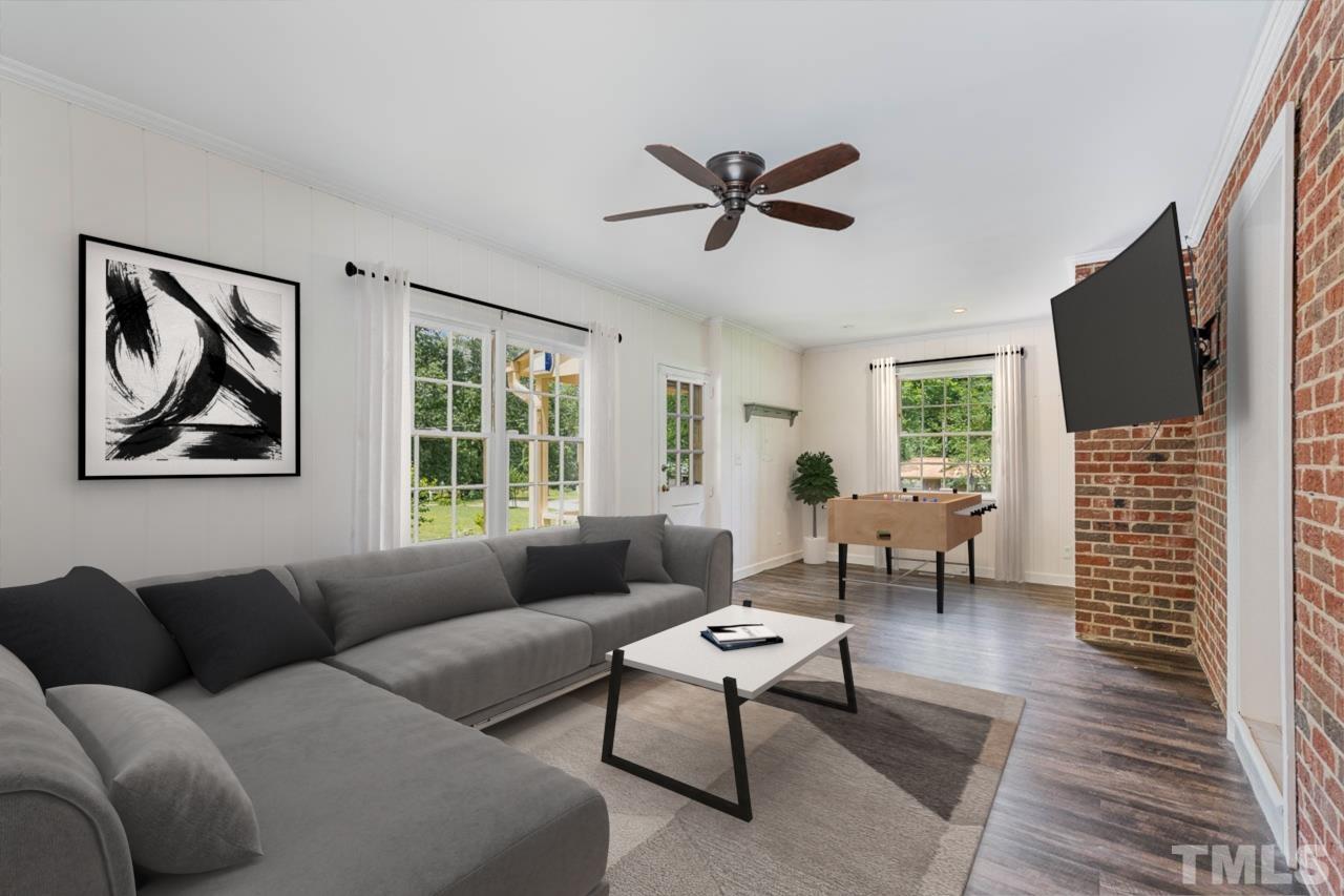 3406 Forest Road Raleigh, NC 27604 - Photo 22 of 31 a living room with furniture a flat screen tv and a window