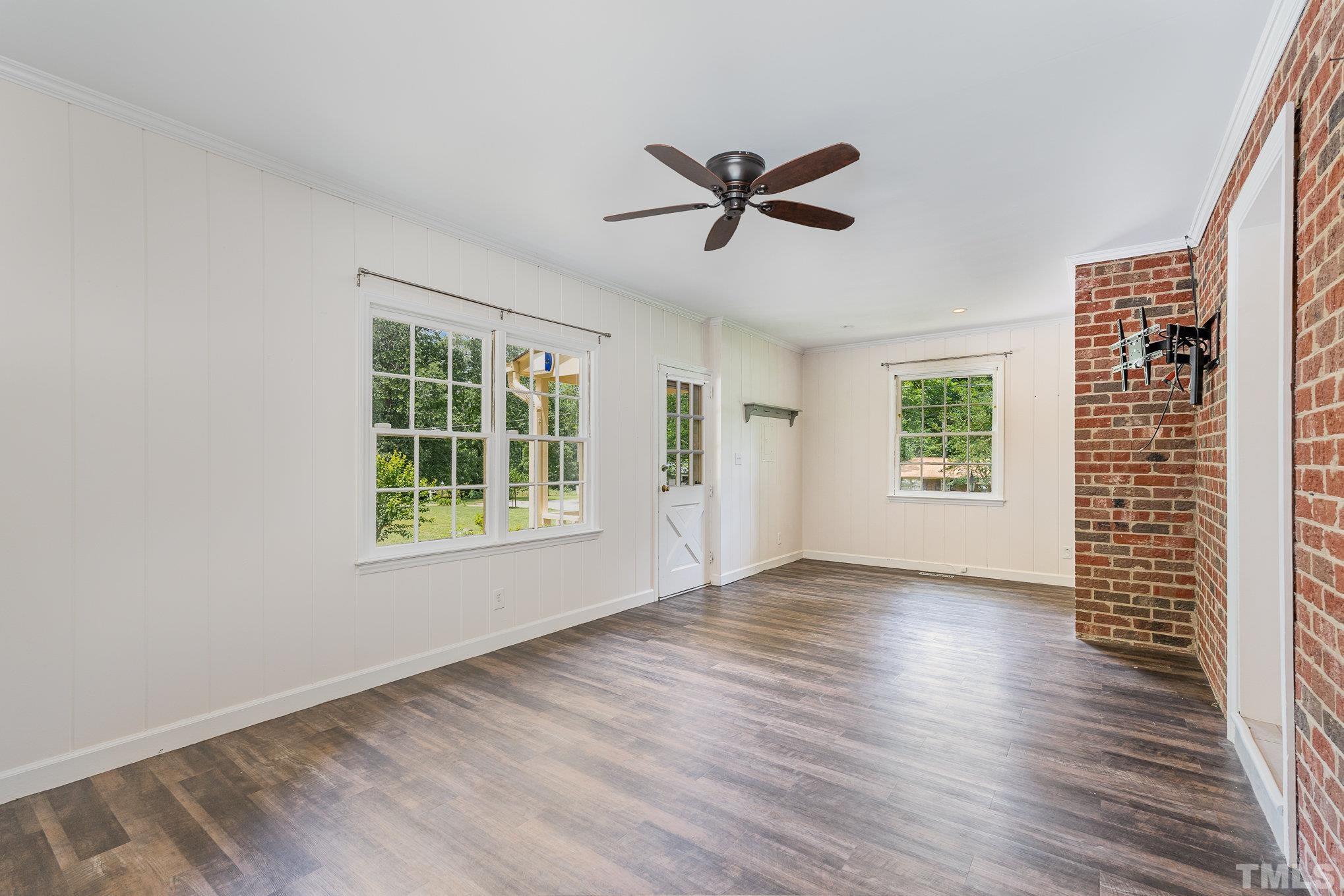 3406 Forest Road Raleigh, NC 27604 - Photo 23 of 31 a view of empty room with wooden floor and fan