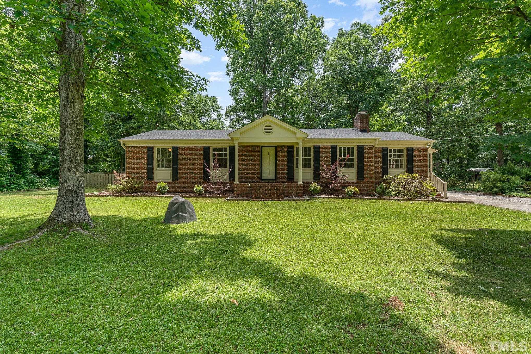 3406 Forest Road Raleigh, NC 27604 - Photo 3 of 31 a view of a house with a swimming pool and a yard