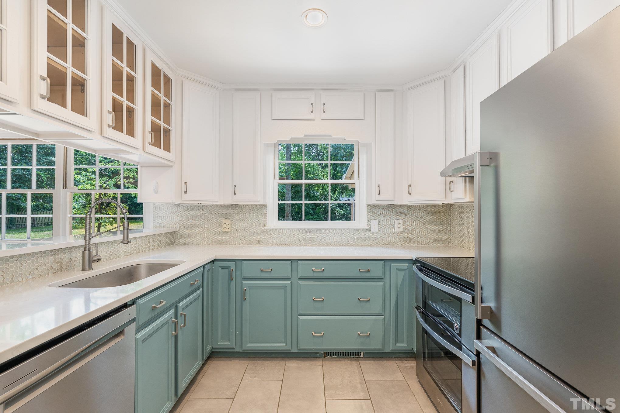 3406 Forest Road Raleigh, NC 27604 - Photo 8 of 31 a kitchen that has a sink and a stove