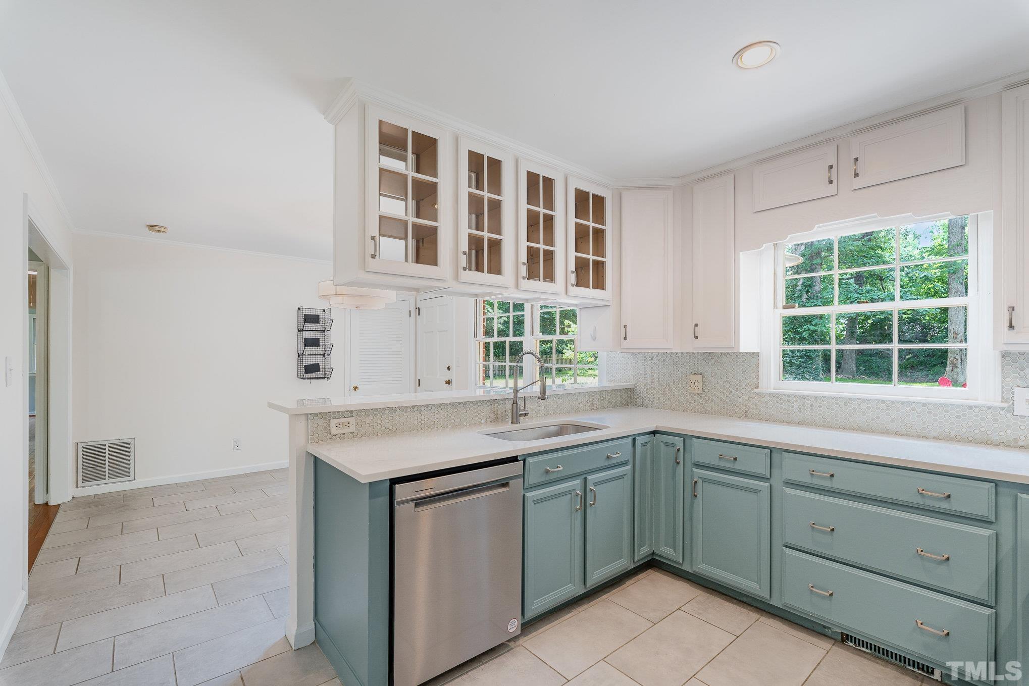 3406 Forest Road Raleigh, NC 27604 - Photo 9 of 31 a kitchen with a sink stove and cabinets