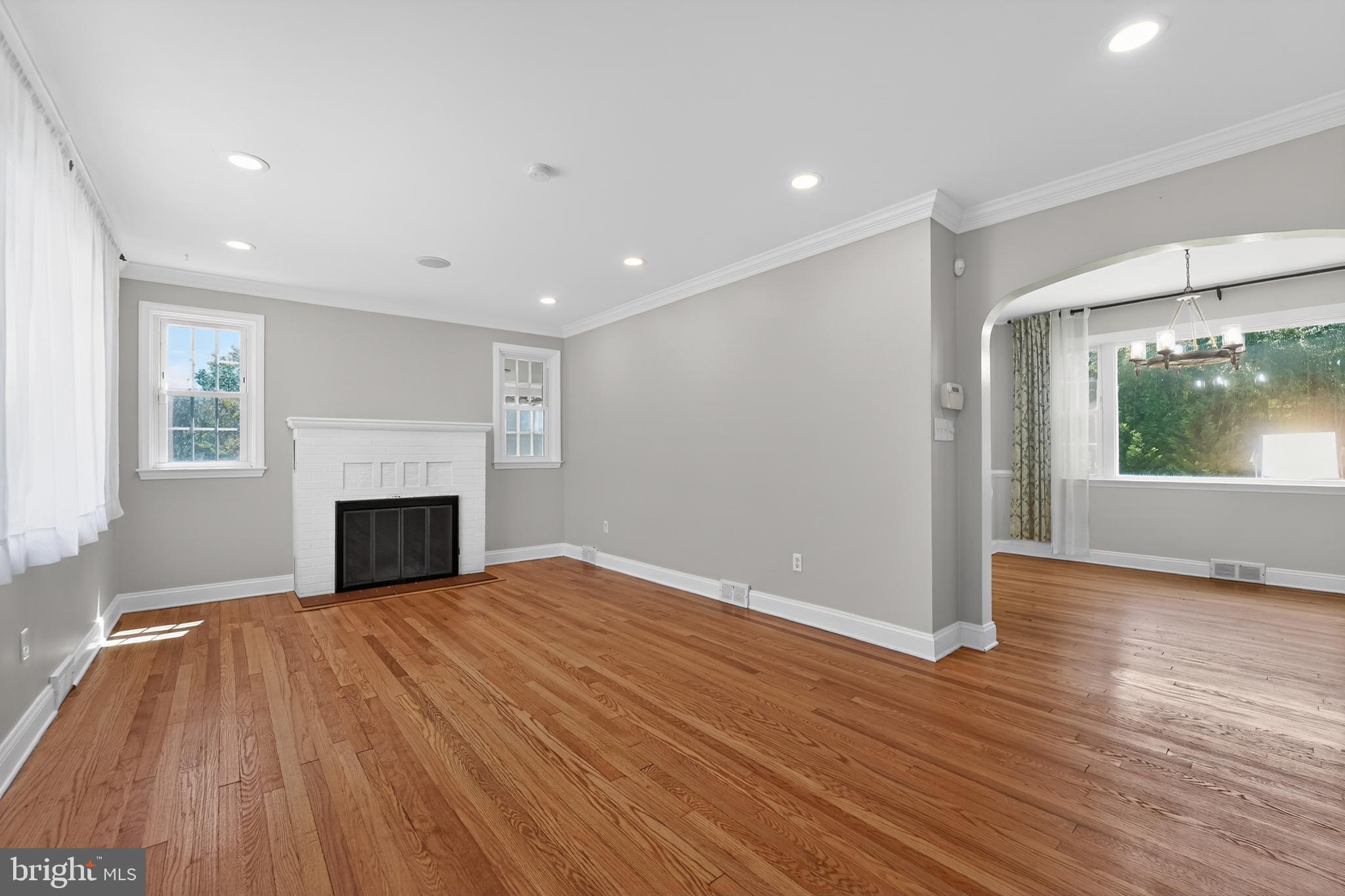9408 Dana Vista Road Baltimore, MD 21236 - Photo 10 of 38 a view of empty room with wooden floor and fireplace